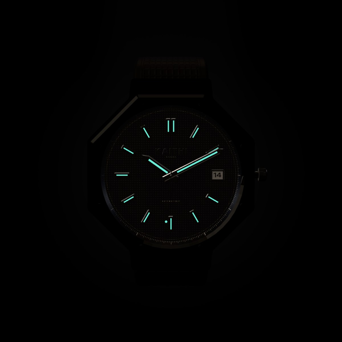 The K-01 in the dark, its hands and hour markers glowing blue-green.
